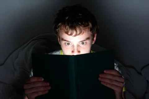 Reading at night Stock Photos