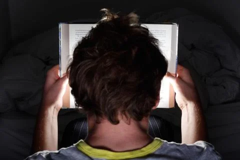 Reading at night Stock Photos