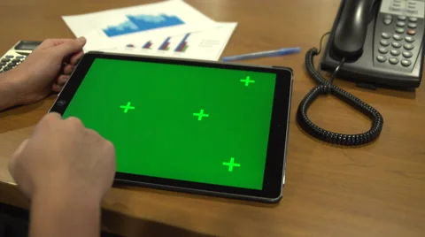 Reading or Watching iPad Pro at Work Desk Green Screen Stock Footage