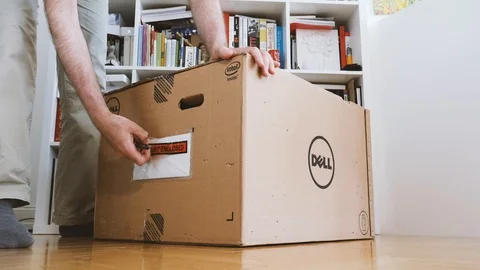 Reading packaging list of new dell computer Stock Footage 90692950