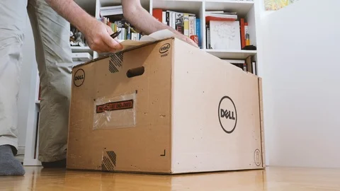 Reading packaging list of new dell computer Stock Footage 90692956