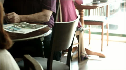 Reading the paper at a cafe Stock Footage 22665059