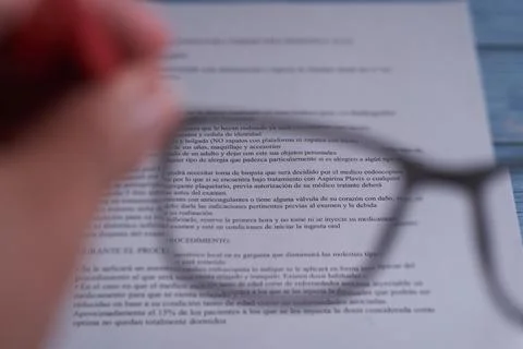 Reading a piece of writing through the optical lens, focus and defocusing Stock Photos