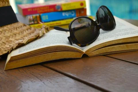 Reading by the pool Stock Photos
