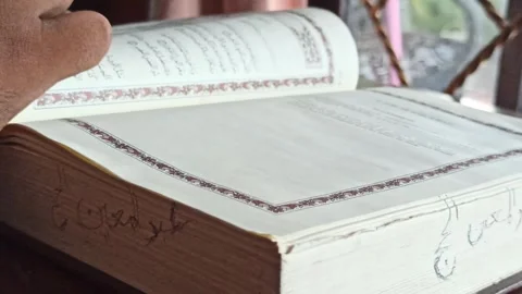 Reading the Quran with Translation Stock-Footage 255085686