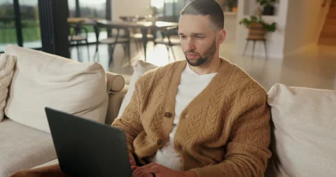Reading, remote work and man with laptop on couch, wireframes planning and Stock Footage 335299825