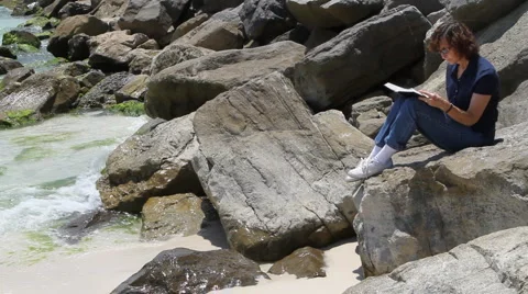 Reading On Rocks Video stock 5478646