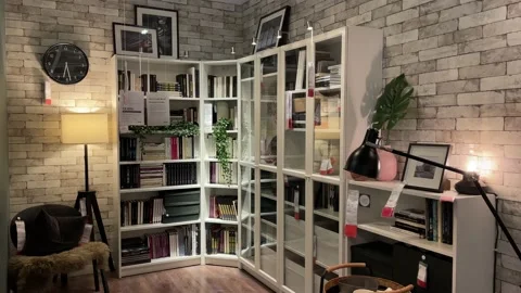 Reading room at IKEA Store. Study room with bookshelf and beautiful lighting Video stock 172348562