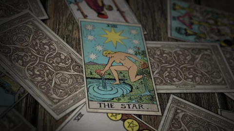 Reading The Star tarot card during a future forecasting spiritual spell Stock-Footage 305948378