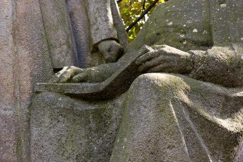Reading stone statue Stock Photos