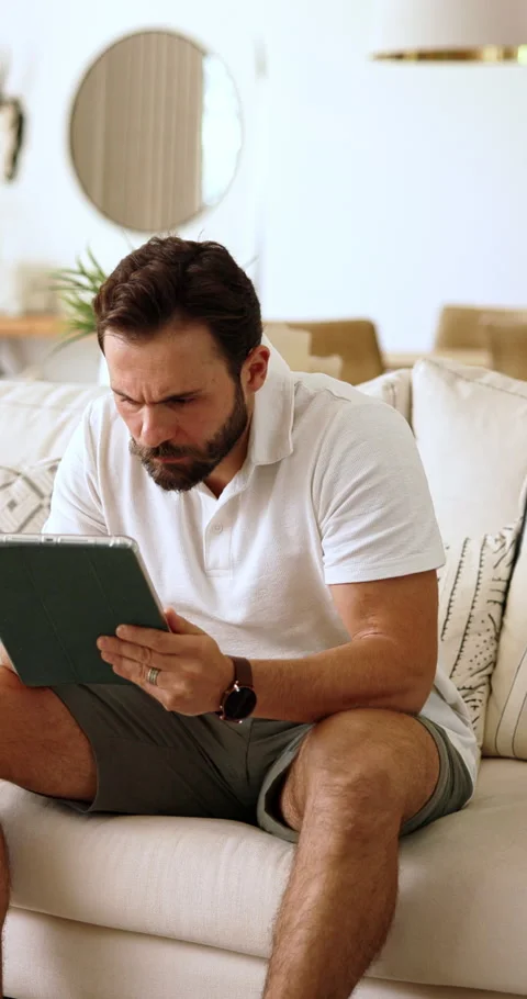 Reading, tablet and man on sofa in home with relax for blog on saving, Stock Footage 337689930