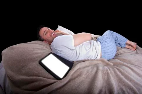 Reading Tablet in Bed Stock Photos