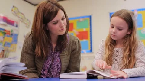 Reading with teacher Stock Footage 22665564