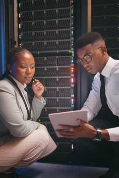 Reading, team or engineer with tablet by server rack, upgrade plan or mainframe Stock Photos