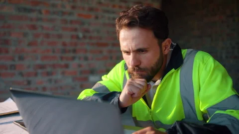 Reading, thinking or man with laptop at construction site, engineering or Stock Footage 336203130