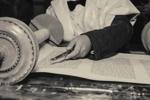 Reading a Torah scroll during a bar mitzvah ceremony . Stock Photos