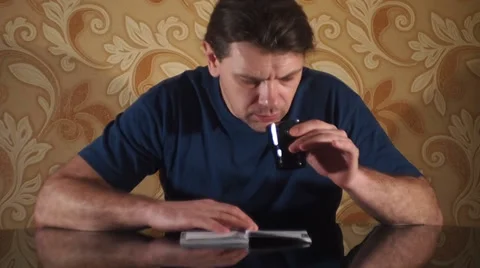 Reads the brochure, drinking a beverage Stock-Footage 35720406