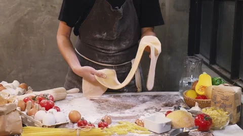 Ready to Bake: Person in Apron Holding Fresh Dough Stock Footage 300063767