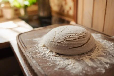 Ready for baking bread dough in flour, ornate with patterns Stock Photos