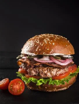 Ready be served classic hamburger with cherry tomatoes 1 . High quality and Stock Photos