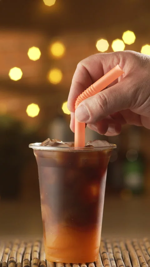 Ready Bumble coffee with fresh orange juice served in plastic cup with ice... Stock Footage 338189939