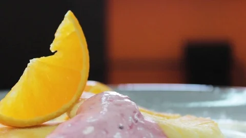 Ready cheesecakes with two sauces and a slice of orange on a plate Stock Footage 112508850