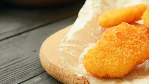 Ready chicken nuggets on a paper Stock Footage 70094669