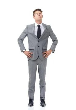 Ready to climb the corporate ladder. A young businessman standing with his hands Stock Photos