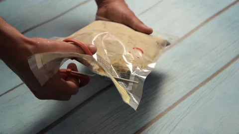 Ready to cook chicken packet opening using scissor Video stock 166090867