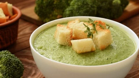 Ready cream - soup with broccoli in white bowl Video stock 70059077