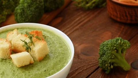 Ready cream - soup with broccoli in white bowl Stock Footage 70060659