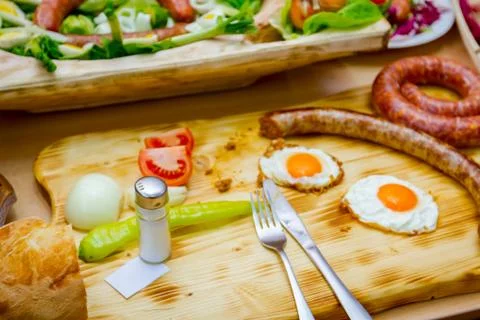 Ready for eating, fried eggs and sausage, onion, green peppers, tomato Stock Photos