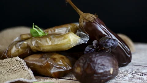 Ready-to-freeze eggplants in a vacuum bag lie on a paper baking sheet Stock Footage 315115178