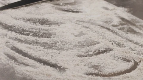 Ready fresh pita bread falls on the table with flour. Slow motion video Stock Footage 114305476