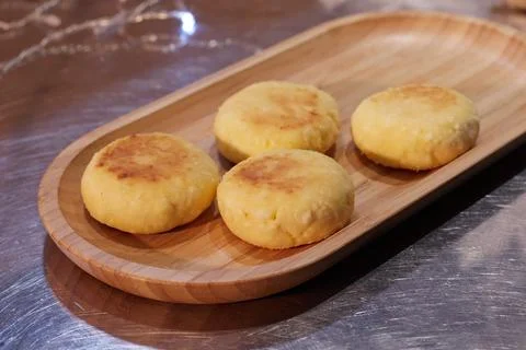 Ready fried cheesecakes lie in a plate on a tray on the table the background is Stock Photos