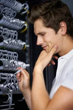 Ready to get you back online. A computer technician connecting cables. 写真素材