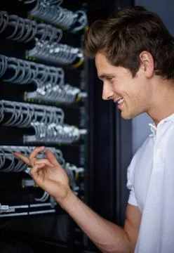 Ready to get you back online. A computer technician connecting cables. 写真素材