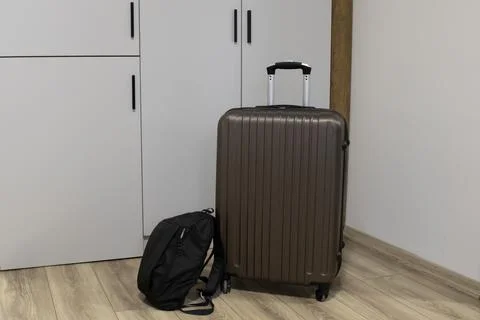 Ready to Go Suitcase and Backpack by the Hotel Wardrobe Stock Photos