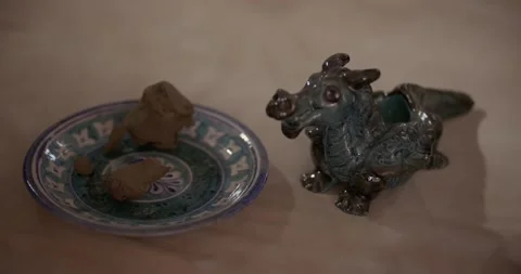 Ready-made burnt and painted clay figurines in the studio of a ceramist Stock Footage 246989267