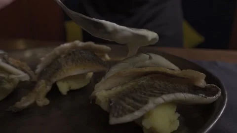 A ready-made dish with fish, drizzled with sauce, slow motion Stock Footage 322011812