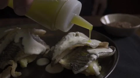 Ready-made fish dish, sprinkled with additional sauce, butter Stock Footage 322011828