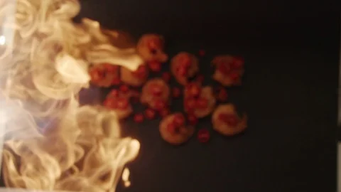 Ready-made fried shrimp with chili peppers fly up with fire. Slow motion video Stock Footage 116649529