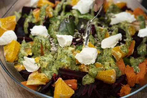 Ready-made grilled beetroot, pumpkin, orange, cream cheese salad. Stock Photos