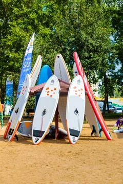 Ready-made inflatable surfboards stand by the post. Preparation for the compe Stock Photos