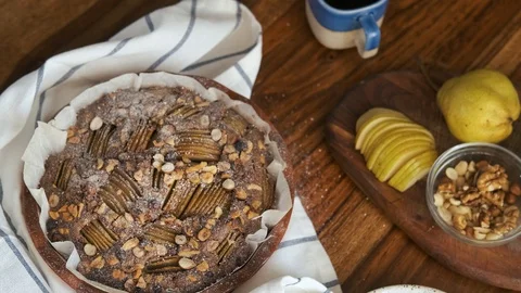 Ready-made pie with pear and nuts on the table and ingredients Stock Footage 127543004