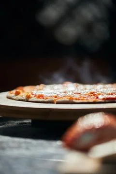 Ready-made pizza on a stand. The process of making Stock Photos
