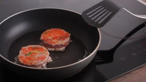 Ready-made salmon and broccoli steaks lie in a pan. fish medallion grilled on Stock Footage 169387264