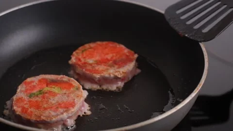 Ready-made salmon and broccoli steaks lie in a pan. fish medallion grilled on Stock Footage 170088690