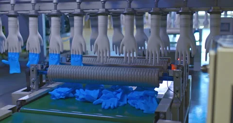 Ready-made silicone gloves are removed from molds, factory production. Modern Stock Footage 155438310