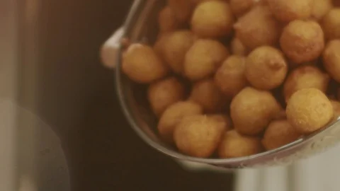 Ready-made Turkish fried donuts Lokma in slow motion falling on pink. Ramadan Stock Footage 113549257